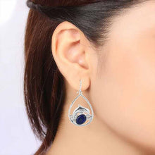 Lapis and Jumping Dolphin Earrings On Ear